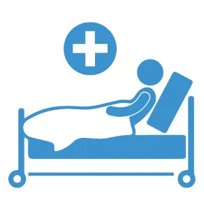 A patient on a hospital bed in a sanitized and fully equipped room.